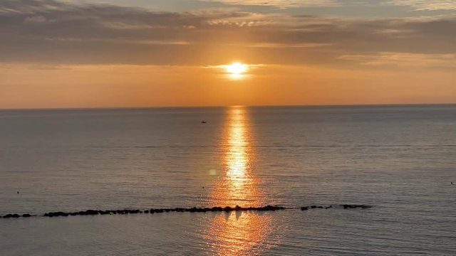 Sunset timelapse with the sea, clouds and sun in the view. November in Cyprus.