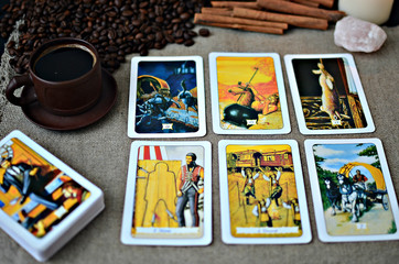 Tarot cards and fortune telling, canvas napkin background, coffee сup and coffee beans