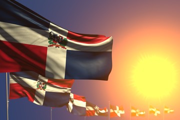beautiful many Dominican Republic flags on sunset placed diagonal with bokeh and space for text - any holiday flag 3d illustration..