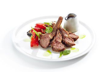 Grilled Lamb Rack with Baked Vegetables on White Restaurant Plate