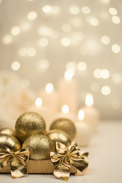 Box with golden christmas ball on golden star bokeh background