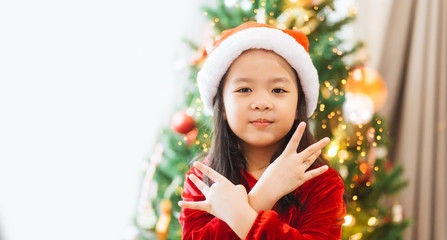 Little asian girl smile and posing dance on christmas tree and white background.Child girl happy and dancing in Christmas celebration and Happy New year concept.