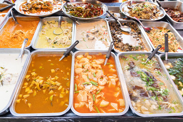 Many delicious Thai foods on tray at the daily fresh food Market.