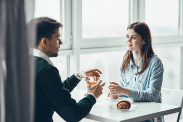 young couple having breakfast in the kitchen