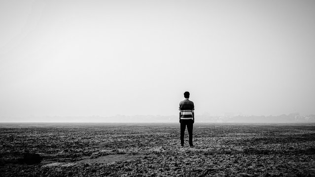 Depressed man standing in the mid-desert