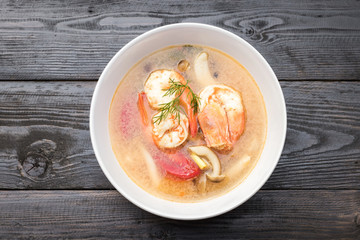 Spicy clear soup with fresh herbs 
