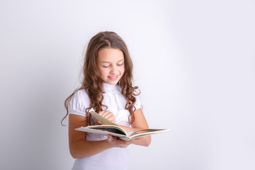 Teenage girl with a book in her hands on a white background. Shows emotions joy, surprise, sadness.