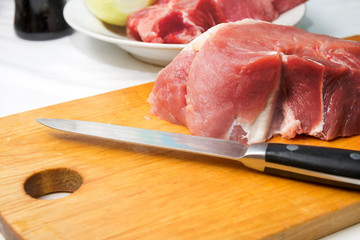 Slices of fresh raw meat on a cutting kitchen board. Cooking food