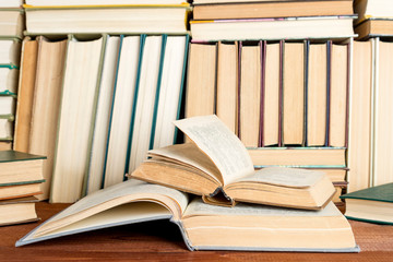 Open book on wood desk in the library room  for education background and back to school concept.