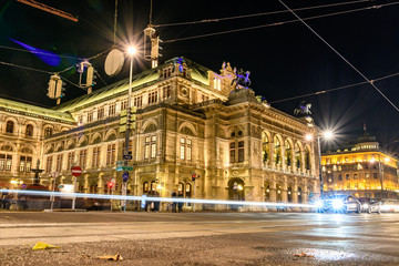 long time exposure of the illuminated Vienna State Opera in Austria at night, light trails