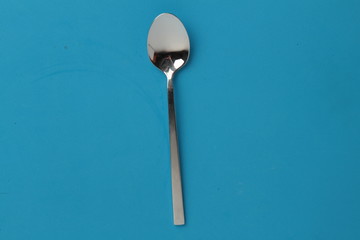 silver spoon isolated on colorful background