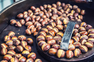 Roasted chestnuts in a frying pan somewhere in the street market