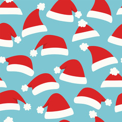 Christmas seamless background with red Santa hats. Vector
