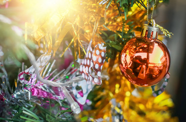 Blurry of Christmas and New Year's balls with beautiful decorations on the Christmas tree, soft light, beautiful background images and illustrations.