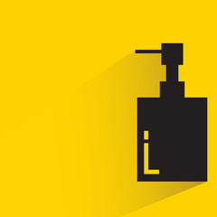 perfume bottle with drop shadow yellow background