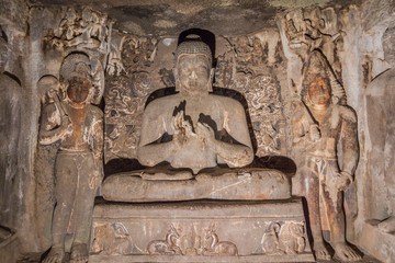 AJANTA, INDIA - FEBRUARY 6, 2017: Buddha image in a  monastery (vihara) carved into a cliff in Ajanta, Maharasthra state, India