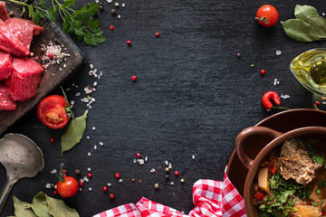 Raw beef fillet ready for grilling. Veal fillet on a wooden cutting board with cherry tomatoes, hot pepper and herbs. Ingredients for soup or borsch. copy space. top view