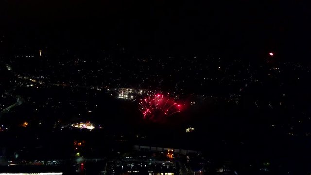 Aerial drone shot of a firework display with fanning fireworks.