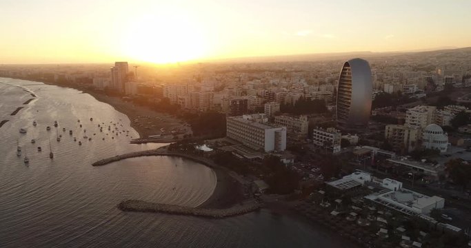 Aerial view of the Mediterranean coast line and Limassol city center. Limassol seaside, yacht marina and water sport recreation. Drone view of the coastal city at sunset. Limassol, Cyprus.