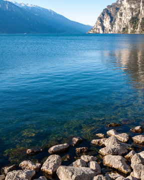 Panorama of Lake Idro from the town of Anfo, with a tourist and fishing port, a tourist destination for holidays at the lake, at the foot of the Alps immersed in unspoilt nature.