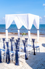 Blue themed wedding setup at the white sandy beach. Romantic getaway wedding. Vertical