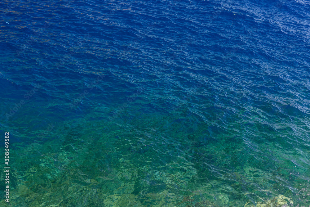 Wall mural deep blue sea water and underwater rocks near hydra island, greece. crystal clear sea water backgrou