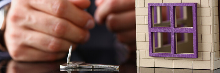 Man in suit and tie and silver key and little