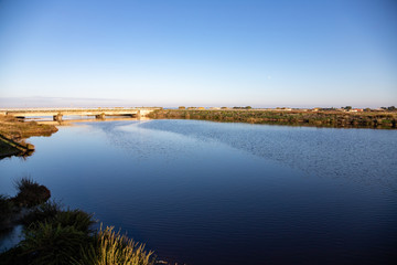 Nature reserve Saline Margherita di Savoia, Apulia, Italy: The salt pan. Salt flats area for sea salt production. A salt marsh, a coastal ecosystem on Adriatic sea.