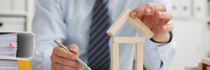 Male hand holds the roof to the lock in