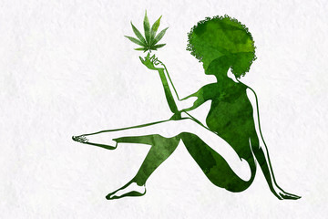 Woman's silhouette with afro hairstyle holding marijhuana leaf in her hand - 308650536