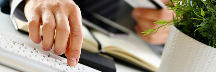 Male arms hold credit card press buttons making transfer