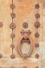 Antique wooden door with a very heavy metal doorknob.