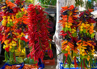 Hanging strings of mixed hot chili peppers for sale at Sineu market, Majorca, Spain