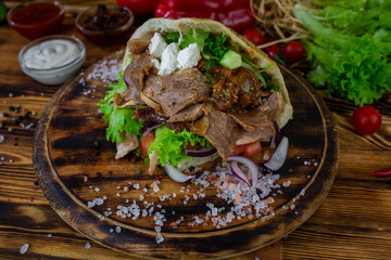 doner kebab on dark wooden kitchen table