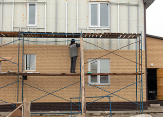 Obraz premium Installation of siding on the walls of the house