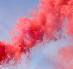 Fototapeta premium Red smoke on a blue sky