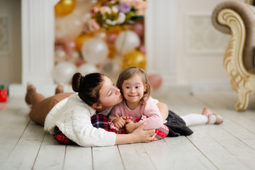 Tender girl with down syndrome and sister teenager