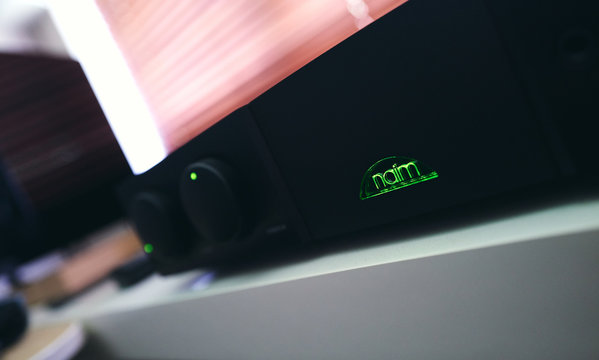 NEWCASTLE UPON TYNE, ENGLAND, UK - AUGUST 01, 2019: A closeup of the green Naim logo on an audiophle Supernait 2 hifi, music amplifier.