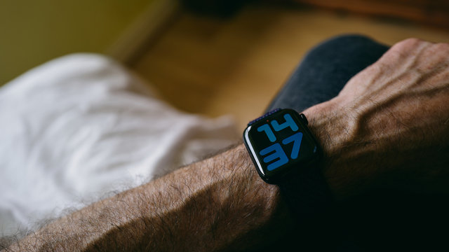 NEWCASTLE UPON TYNE, ENGLAND, UK - AUGUST 03, 2019: A Closeup Of The Arm Of A Caucasian Adult Man Wearing An Apple Watch With Large Numbers For Watch Face.