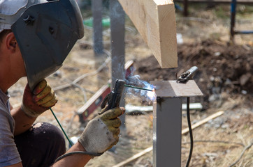 Worker welds metal at a construction site