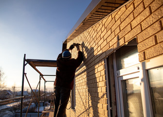 Installation of siding on the walls of the house
