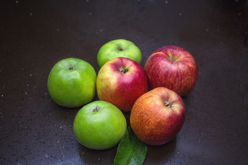 fruits on the table still life many fruits dark table green red apple yellow orange leaf neon highlight