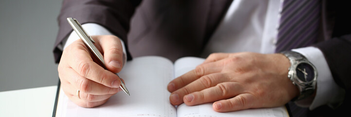 Hand of businessman in suit filling