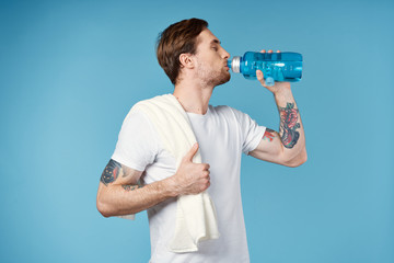 man drinking water from bottle