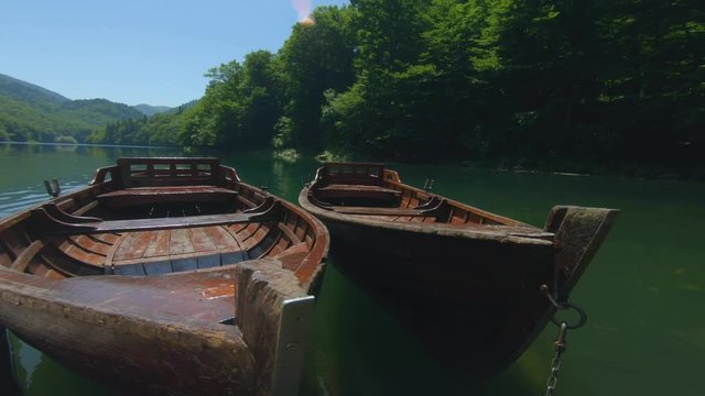 Small boats moored at the pier on Lake Biograd in Montenegro. Tourist trip and Travel. Romantic mood. Beautiful nature in summer daytime. Vacation