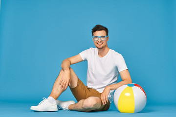 Fototapeta na wymiar man sitting on ball and holding a ball