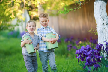 Fototapeta premium Two handsome brothers having fun while sitting outside in garden.