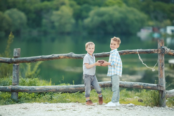 Naklejka na ściany i meble boys playing in the banks of the pond.