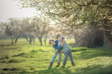 Two friends in the summer in the Park have fun and frolic outdoors.