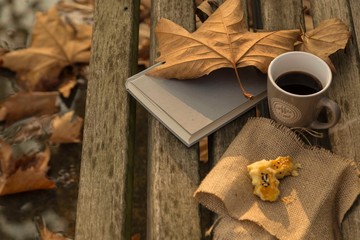 .fall leaf and coffee on bench . autumn concept